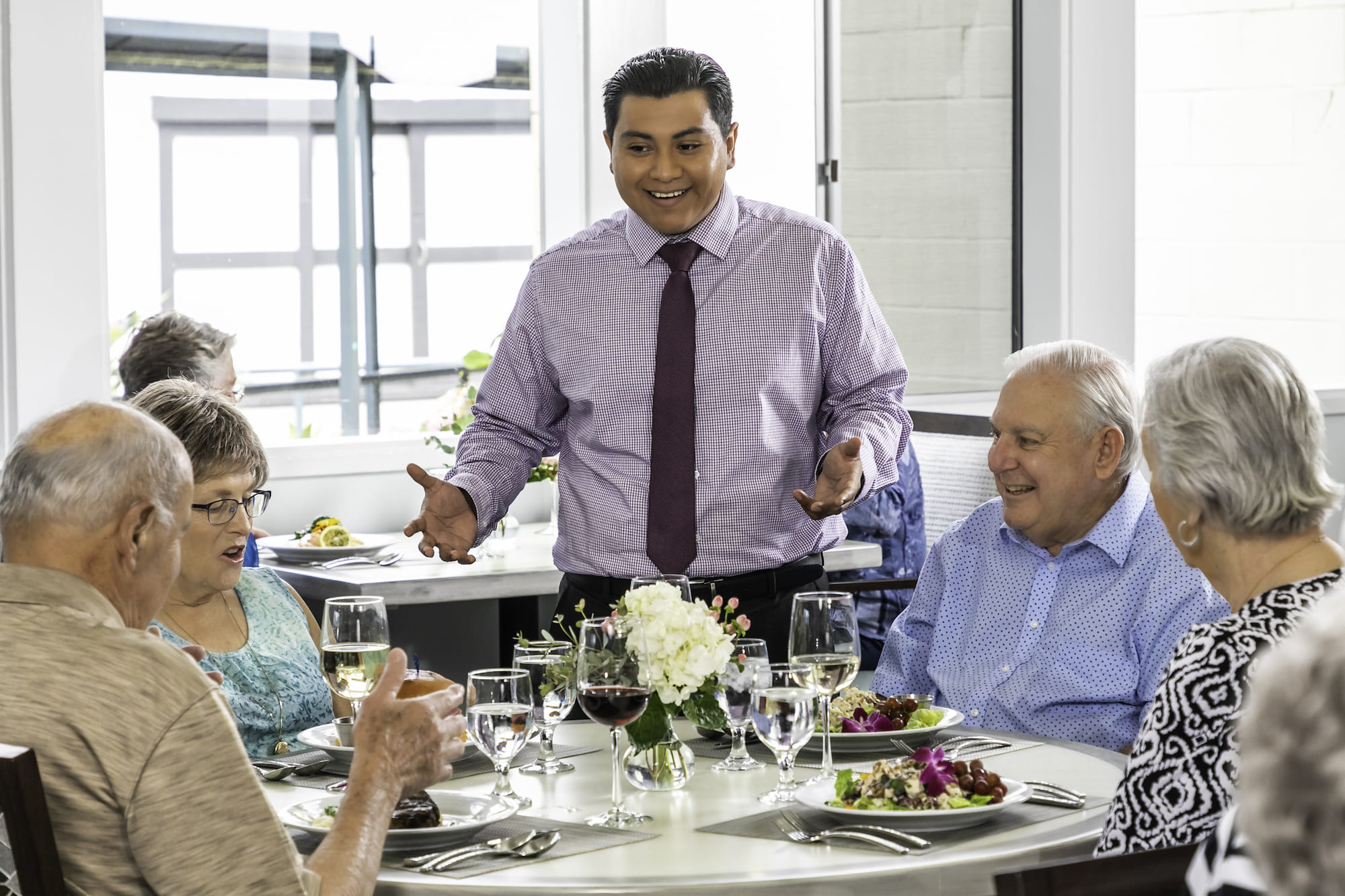 purple shirt server and table of 4 people